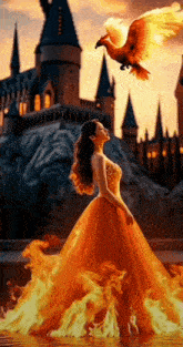 a woman in a fire dress stands in front of a castle with a bird flying overhead