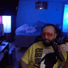 a man wearing sunglasses and a yellow shirt that says hbo