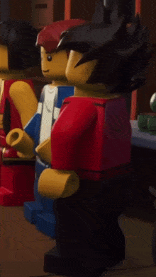 a group of lego figures standing next to each other