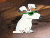 a white cartoon dog wearing green sunglasses is sitting on the floor .