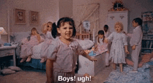 a little girl is standing in a room with a group of children and says `` boys ! ugh ! ''