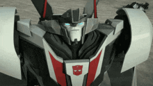 a close up of a transformer with a red and white emblem
