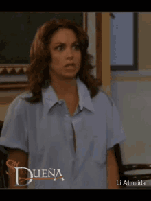 a woman in a blue shirt has the word duena on the bottom