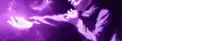 a person is holding a purple object in their hand in a dark room .