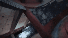 a blurry picture of a dark hallway with a red sign that says ' emergency exit '