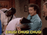 a group of men are standing around a man with the words chug chug chug written in yellow