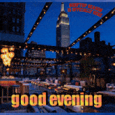 a rooftop season is officially here and the empire state building is lit up in the background
