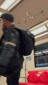 a man walking on a train with a sticker on the door that says ' ambulance '