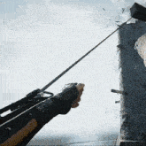 a person holding a spear in front of a tower