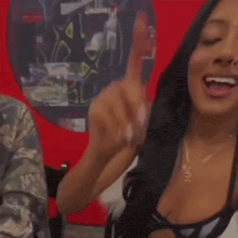 a woman in a black bra is smiling and looking at the camera