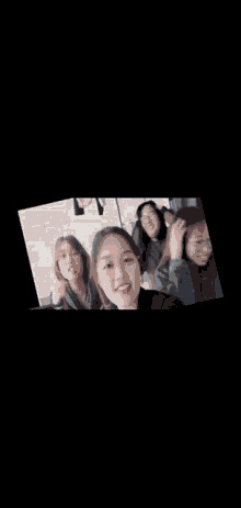 a group of young women are sitting next to each other and smiling .