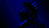 a cartoon character with blonde hair and a black hat with purple ribbons