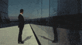 a man stands on the edge of a building looking out over a city