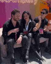 three people sit on a couch in front of a sign that says ' amplify '