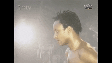 a man without a shirt is standing in front of a mgm logo