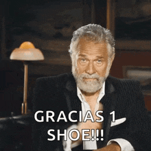 a man giving a thumbs up with the words gracias 1 shoe written below him