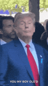 donald trump is wearing a blue suit and red tie and says `` you my boy ole 'd '' .