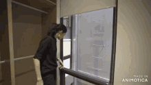 a woman looking out of a window with the words made in animotica below her