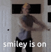 a blurry picture of a man dancing with the words smiley is on behind him