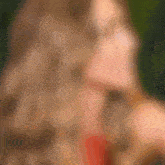 a blurred image of a woman 's face with a green background