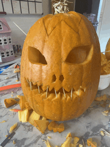 a carved pumpkin with toothpicks sticking out of it 's teeth
