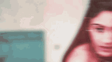 a blurry picture of a woman 's face with a blurred background .