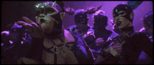 a group of people wearing masks one of which has the word you on it