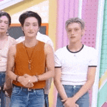 a group of young men are standing next to each other on a stage .