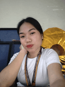 a woman wearing a lanyard that says lyceum of the state bayabas