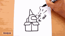 a person is drawing a box with candy coming out of it on a piece of paper titled drawbook