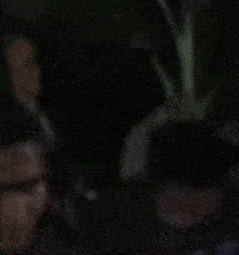 a blurry picture of a man wearing a blue shirt with the letter a on it