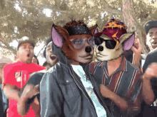 a group of people are gathered in a park with a dog wearing sunglasses and a bandana on his head