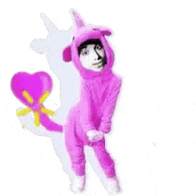 a person in a pink unicorn costume is holding a purple heart .