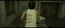 a man in a white shirt and black pants is running in a hallway