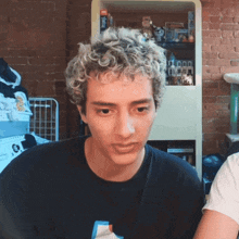 a man with curly hair is wearing a black t-shirt that says snoopy on it