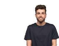 a man in a black t-shirt is smiling and giving a thumbs up