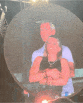 a man and a woman are hugging in front of a circle with a sign that says ' exit ' on it