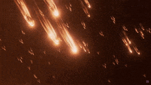 a cluster of comets are falling from the sky above the earth