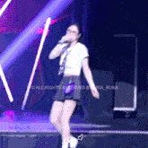 a woman singing into a microphone with the words " all rights reserved " on the bottom