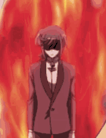 a man in a suit and sunglasses is standing in front of a fire .