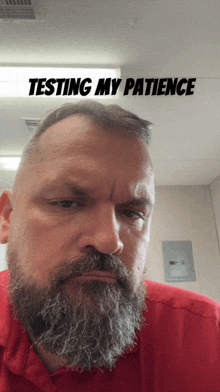 a man with a beard has the words " testing my patience " above his head
