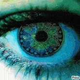a close up of a woman 's eye with a mandala in the center