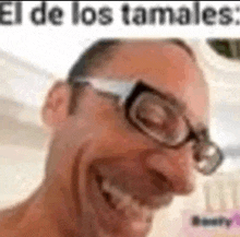 a man wearing glasses is making a funny face and smiling .