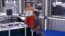 a man is playing a piano while a woman stands behind him with the words www.bandicam.com on the bottom
