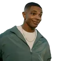 a man wearing a green jacket and a white shirt smiles