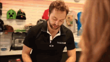 a man wearing a black shirt that says oakley on it