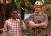 a man wearing a crown is standing next to another man
