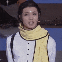 a man wearing a white shirt and a yellow scarf with hearts around him