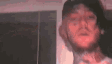 a close up of a man 's face with a beard and a hat .
