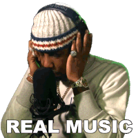 a man wearing a hat and headphones is singing into a microphone with the words real music written below him